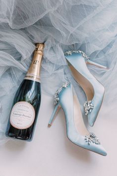 a bottle of champagne next to a pair of high heeled shoes