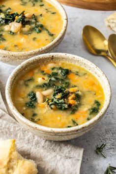 two bowls of soup with spinach and cheese