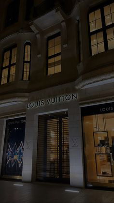 louis vuitton store front at night with its lights on and windows lit up