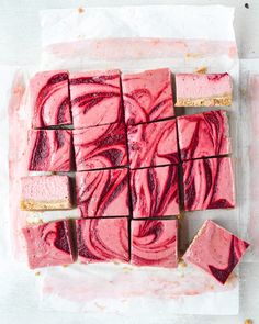 red and pink swirled fudges on parchment paper, cut into squares with gold edges