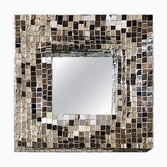 a mirror that is made out of small tiles and has a square frame in the middle