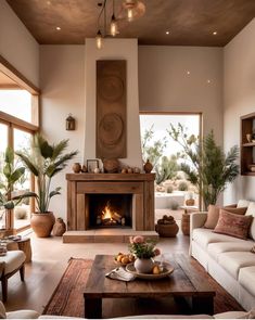 a living room filled with furniture and a fire place in the middle of a room