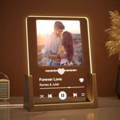 a wooden frame with an image of a man and woman in love on the screen