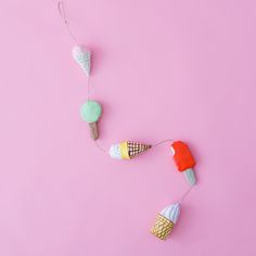 two ice cream cones on a pink background