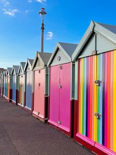 a row of colorful beach huts sitting next to each other