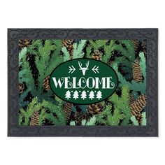 a welcome mat with pine cones and evergreen trees