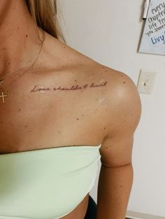 a woman with a cross tattoo on her chest and the words, i am not afraid to hear