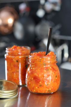 two jars filled with food sitting on top of a table