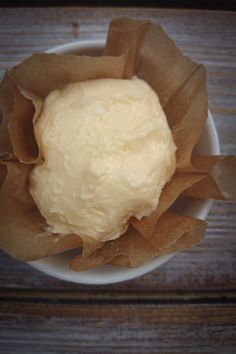 a white bowl filled with food on top of a wooden table