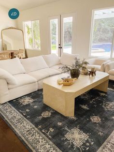 a living room filled with furniture and a large rug