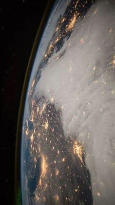 the earth is seen from space at night with lights shining on it's side