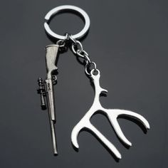 Material: Steel metal alloy for durability and a rugged look Color: Black hunting rifle and silver deer antler charms provide a striking contrast Versatile Use: Can be used as a keychain or attached to bags, backpacks, or gear as a decorative charm Gift Idea: Ideal for hunting enthusiasts, outdoor lovers, and as a themed gift for various occasions