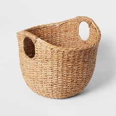 a large woven basket with a hole in the middle and a handle at the bottom