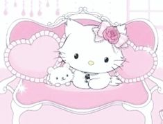 a hello kitty bed with a teddy bear on it and a pink rose in the middle