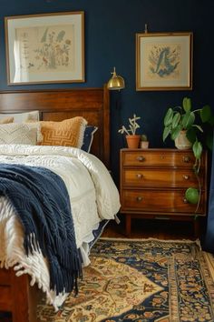 a bed room with a neatly made bed and two pictures on the wall above it