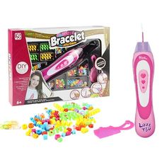 a pink electric toothbrush with lots of candy in front of it and its packaging