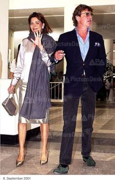 a man and woman walking through an airport