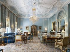 a living room filled with furniture and a chandelier