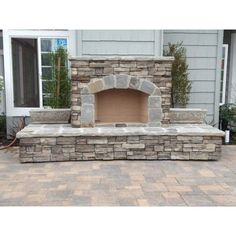 an outdoor fireplace built into the side of a house