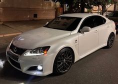 a white car is parked on the street