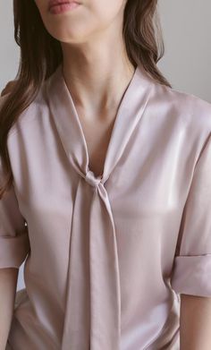 A forever elegant classic. This versatile bow blouse is a dynamic beauty: think Madame President to romantic rendezvous – she can do it all. Wear the neck tie on, off, half-way, or tie it into a bow for a look of class and sass. Removable neck bow to switch up your look. A classy v-neck cut. Concealed button placket for an elegant finish. 100% MULBERRY CHARMEUSE SILK – Washable Elegant V-neck Top With Bow, Formal Silk Tie-neck Blouse, Formal Silk Tie Neck Blouse, Silk Tie Neck Blouse For Formal Occasions, Chic Evening Top With Detachable Bow, Elegant Silk Tie Neck Top, Elegant Party Top With Bow, Elegant Spring Tie Neck Blouse, Elegant Silk Tops With Bow Detail