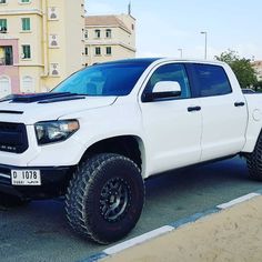 a white truck parked in a parking lot