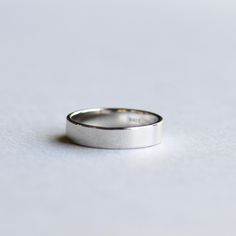 a wedding ring sitting on top of a white surface