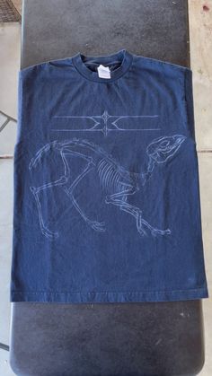 a blue t - shirt with a drawing of a horse on it sitting on top of a table