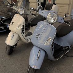 two motor scooters parked next to each other