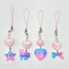 four different colored heart and star shaped charms