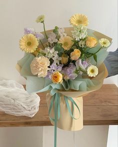 a bouquet of flowers sitting on top of a wooden table