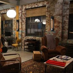 a living room filled with furniture and lots of windows