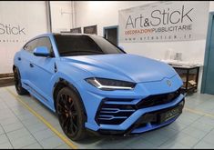 a blue sports car parked in a showroom