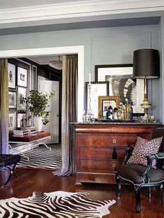 a living room with zebra print rugs on the floor