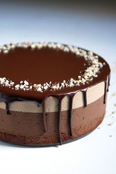 a chocolate cake with white and brown toppings