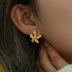 Elevate your style with these elegant Lily Flower Gold Earrings. The intricate lily flower design makes a statement and adds a touch of sophistication to any outfit. Perfect for special occasions or adding a touch of glam to your everyday look. DETAILS & SIZE Sold as a pair Finish: 18K gold plate Material: Stainless Steel Measurements: 17x19mm Weight: 3 grams Comes with friction earring backs Waterproof, tarnish-resistant, and nickel free Shop Earrings to curate your ear stack! Small Earrings Gold, Gold Earrings Indian, Flower Earrings Gold, Neck Pieces Jewelry, Gold Earrings Models, Modern Gold Jewelry, Gold Pendant Jewelry, 2 Earrings, Silver Jewelry Design