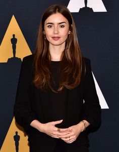 an image of a woman that is posing for the camera on the oscars red carpet