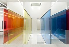 an empty room with multiple colored glass walls