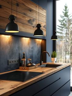 a kitchen with black cabinets and wooden counter tops next to a large window that looks out onto the outdoors