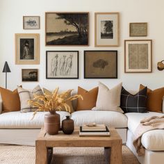 a living room filled with lots of furniture and pictures on the wall above it's coffee table