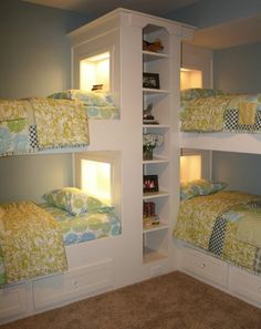 there are three bunk beds with lights on the top and bottom shelves in this room