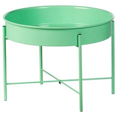 a round table with metal legs and a green tray