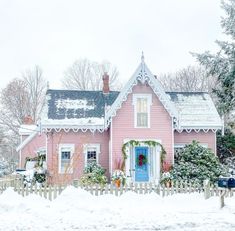 a pink house with snow on the ground