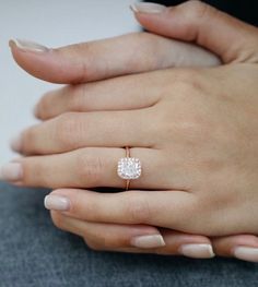 a woman's hand with a diamond ring on it