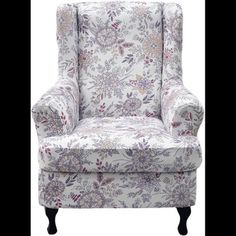 an upholstered chair with floral print on the back and arms, sitting against a white background