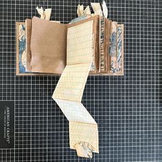 an open book with papers taped to it