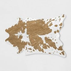 a brown and white spotted cowhide pattern on a white background with the shape of an animal's head