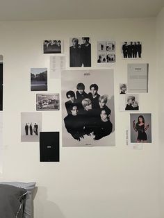 a white wall covered in black and white photos