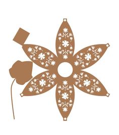 a brown and white snowflake with flowers on it's side, in the shape of an ornament