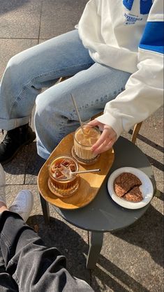 a person sitting on a chair with food in front of them